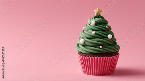 Creative New Year food styling: a single holiday cupcake decorated as a Christmas tree on a clean pink background.

