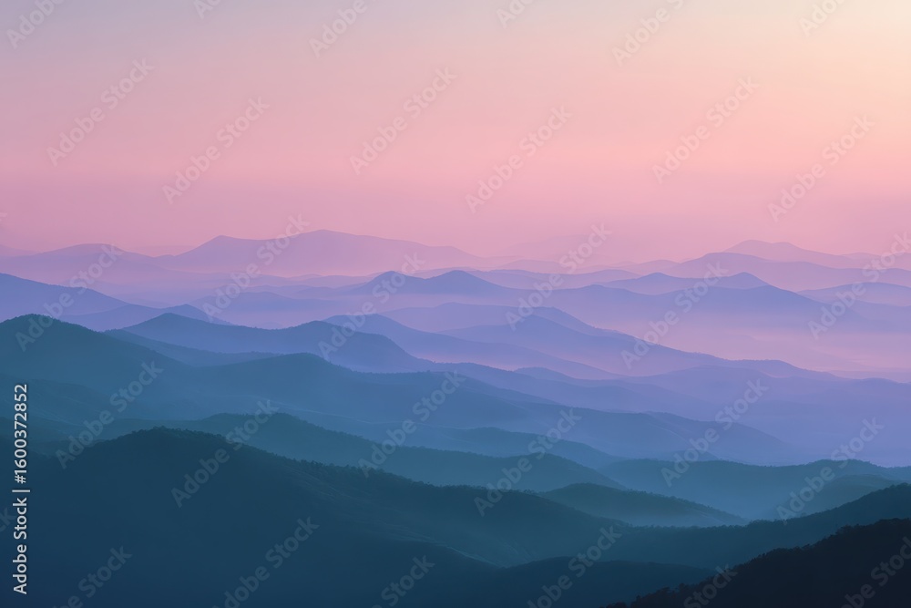 Obraz premium Mountain layers fade into the light purple sky at dusk, with gradient detail