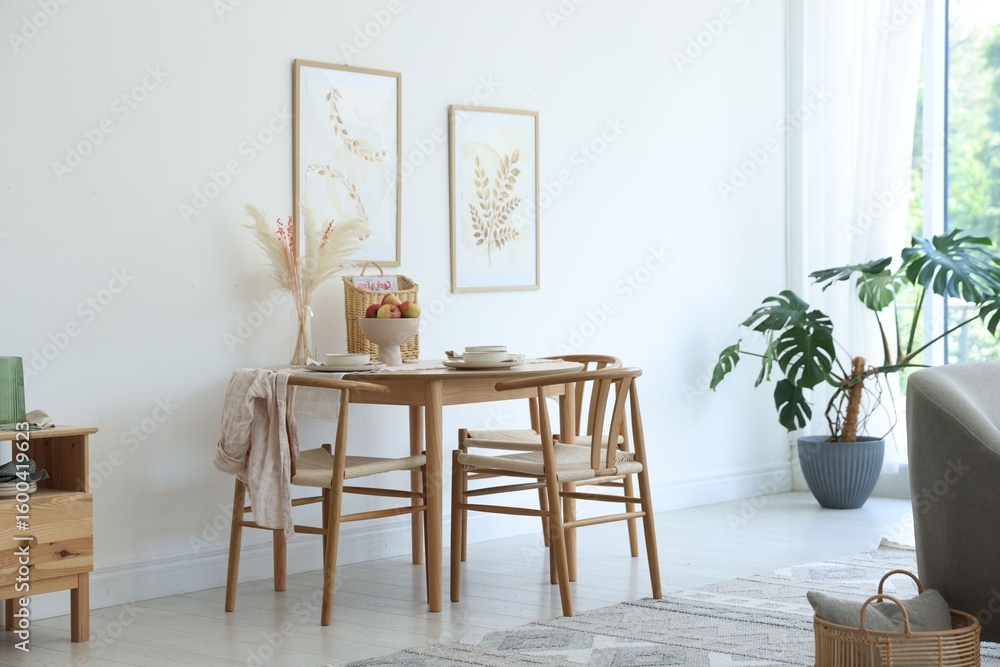 Fototapeta premium Beautiful table setting, chairs and decor in dining room. Interior design