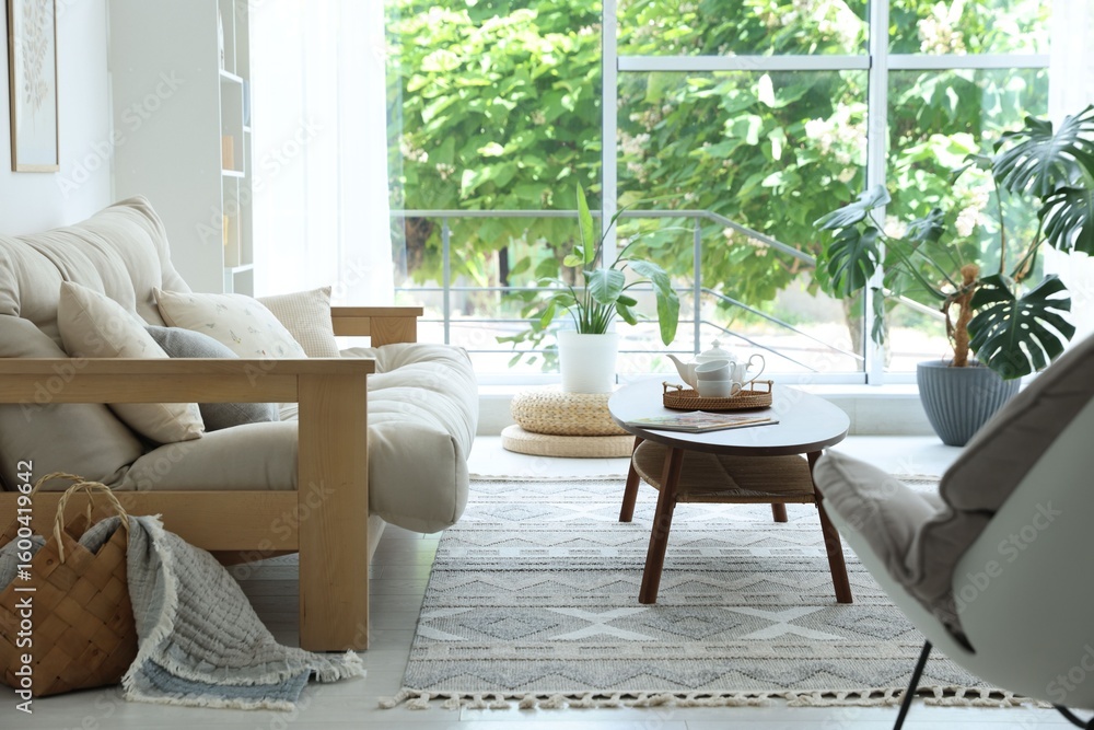 Fototapeta premium Coffee table, sofa and decor in dining room. Interior design
