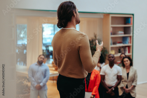 Professional teaches startup principles in informal meeting with attentive audience