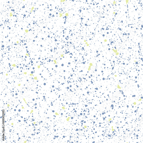 Seamless ink splatter dots pattern artistic blue and yellow spray design