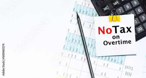 No Tax ON Overtime TEXT is written on Desktop with calculator, pencil on blue background. Conceptual overtime pay symbol. Copy space.
