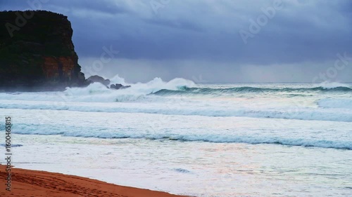 Sunrise seascape with rain clouds at Avalon Beach on the Northern Beaches of Sydney, NSW, Australia.