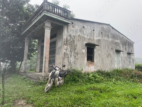 Motorbike in front of Concrete house in Vietnam village