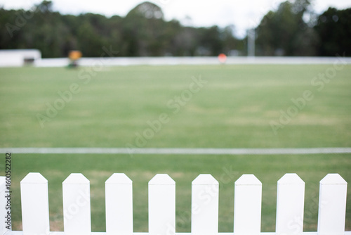 white picket fence around a local cricket field