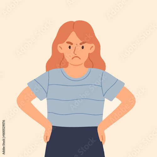 Young woman looking angry with hands on hips and neutral background  
