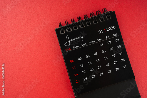 Wallpaper Mural January black desk calendar for 2026 year on red cover background with copy space. Torontodigital.ca