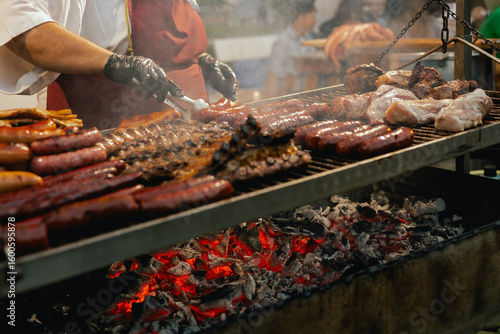 Grilled meat and sausages being served at a lively street festival during the Santos Populares celebration in Lisbon, Portugal. The traditional Portuguese food. Close up, soft focus. Part of a series