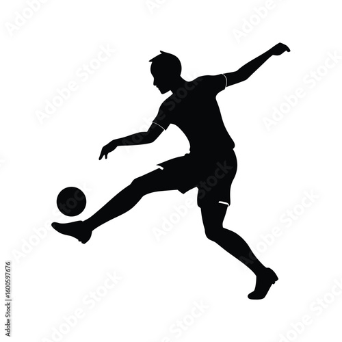 Silhouette of a soccer player kicking a ball