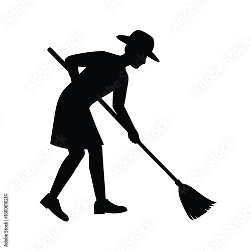 Silhouette of a person sweeping with a broom