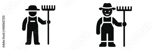 Farmer in overalls holding a rake is working in a rural field during daylight hours