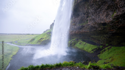 Witness the breathtaking rush of a Seljalandsfoss waterfall as it pours down from towering cliffs in Iceland.