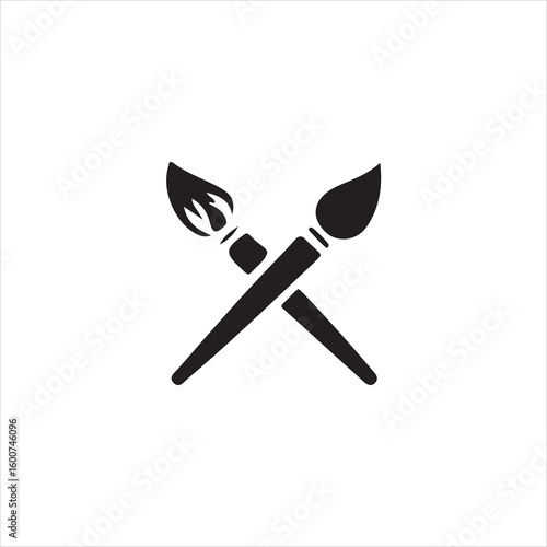Two black paint brushes crossed on a white background artist craft