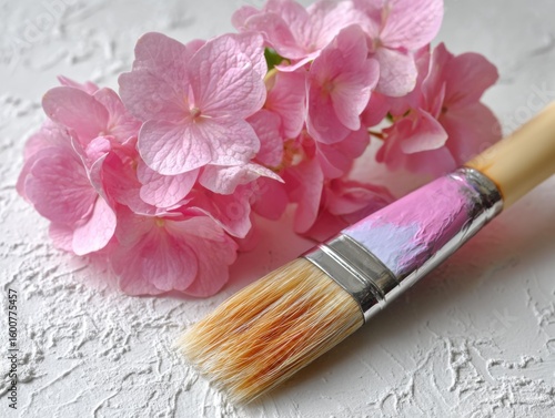 Vibrant pink hydrangeas with a paint brush on a textured background
