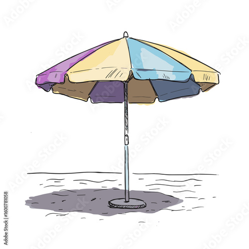 Colorful beach umbrella on sandy surface in summer setting  