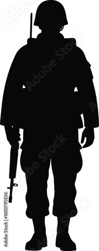 Silhouette of a soldier in a relaxed yet vigilant posture, holding a rifle downwards