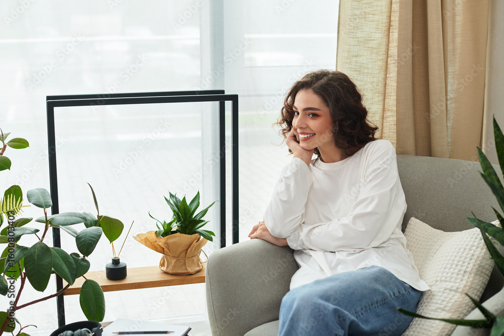 Young woman enjoys a relaxed moment in a bright, modern apartment filled with greenery Young woman enjoys a relaxed moment in a bright, modern apartment filled with greenery