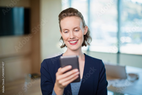 Smartphone sitting on wooden table in meeting room, with wall-mounted screen and scattered papers Free Download Smartphone sitting on wooden table in meeting room, with wall-mounted screen and scattered papers - GFXLoad