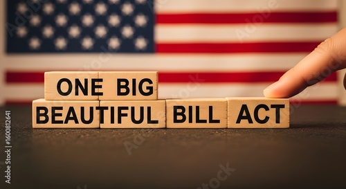Fingers pointing to wooden blocks spelling one big beautiful bill act