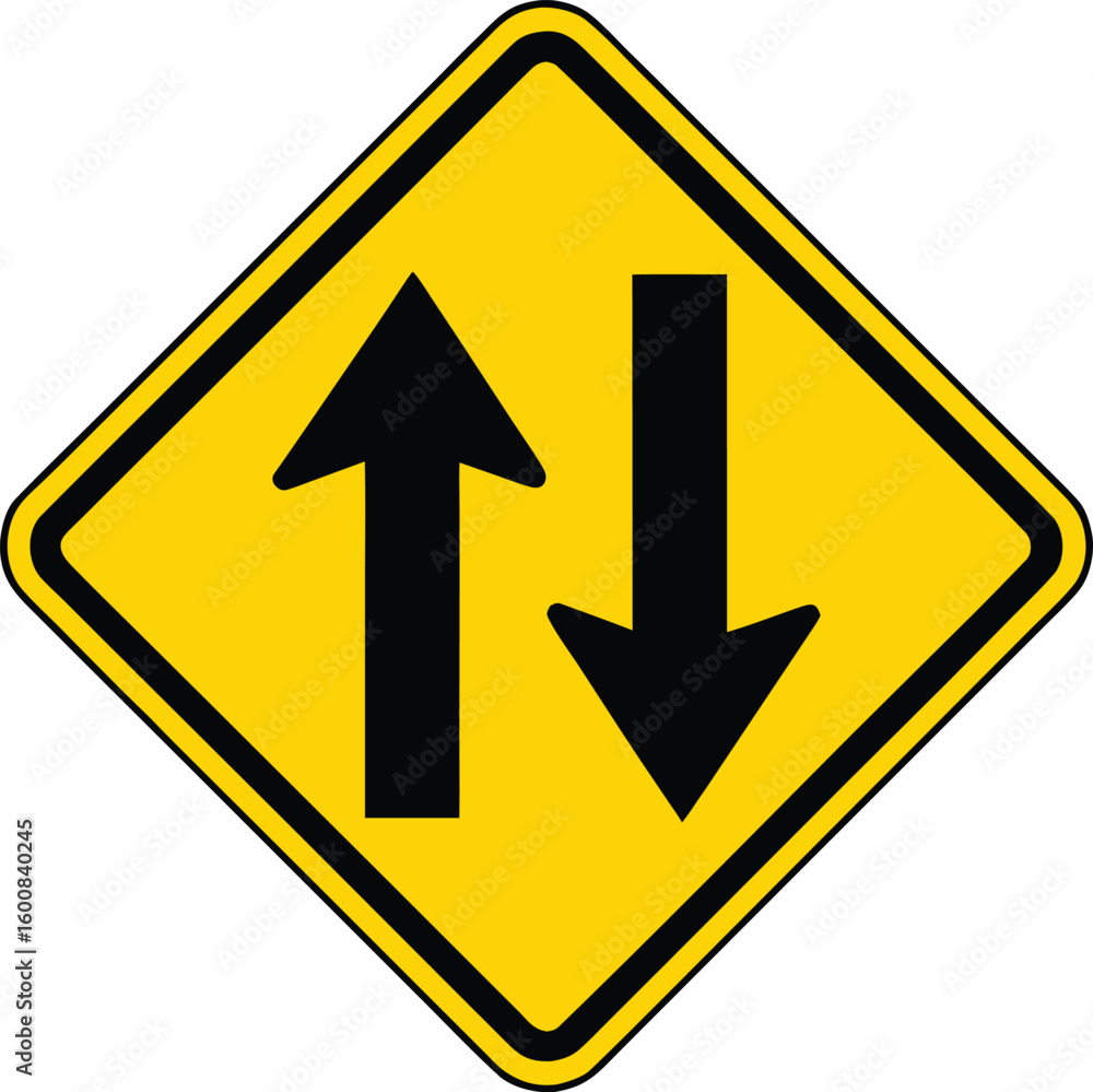 Yellow diamond traffic sign with two opposing arrows indicating two way traffic. Yellow diamond traffic sign with two opposing arrows indicating two way traffic.