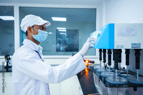 scientist doing experiment using machine. tablet dissolution test. working machine close up. dissolving tablets in a science laboratory. pharmaceutical experiment. tablet dissolving. 