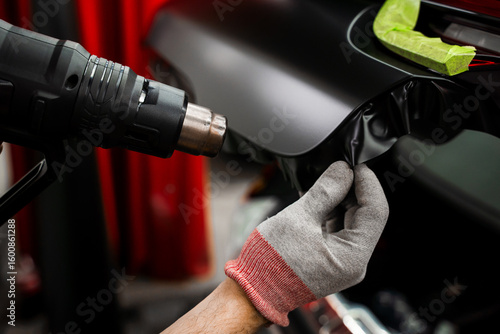 Photos Heat gun used in vinyl wrapping activates adhesive