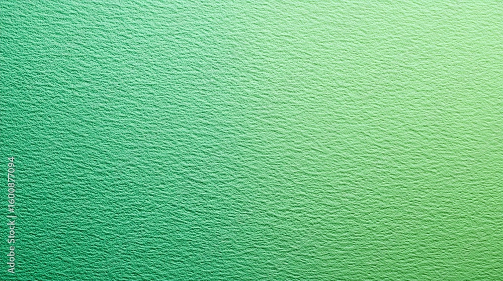 Fototapeta premium Textured green gradient background with subtle variations in shade, creating a soft and soothing visual texture reminiscent of natural surfaces