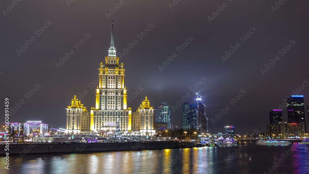 Fototapeta premium Hotel Ukraine winter night timelapse hyperlapse with bridge over Moscow River.