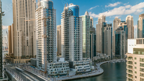 Wallpaper Mural Dubai Marina at evening timelapse with trails of boats on the water and cars traffic, Dubai, UAE Torontodigital.ca