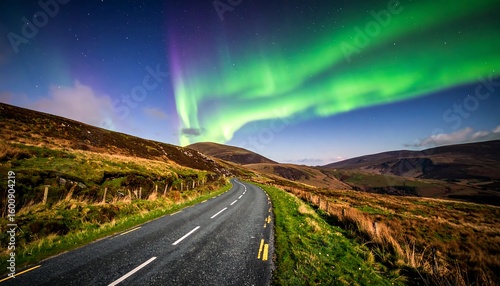Northern lights over a mountain road