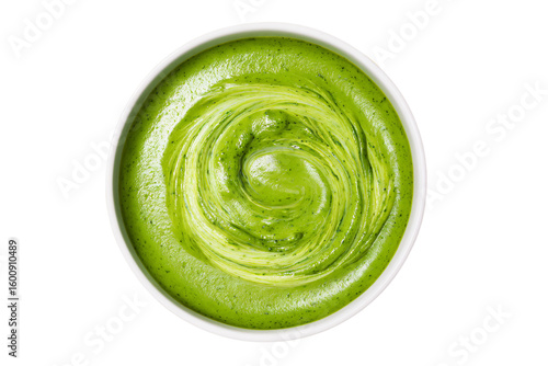 a bowl of green sauce with a spoon