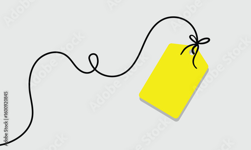 White rectangular tag with rounded corners hanging from a string with a bow on a soft background