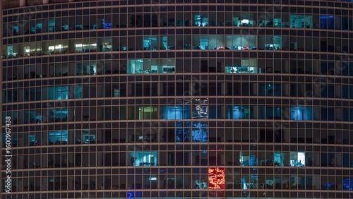 Close up view to office windows in Skyscrapers of City at night timelapse fro...