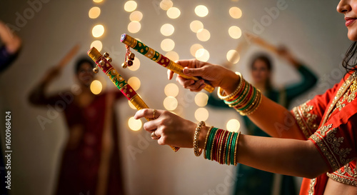 Close Up of Woman's Hands Holding Dandiya  Sticks  with Blurred Background with Bokeh Lights