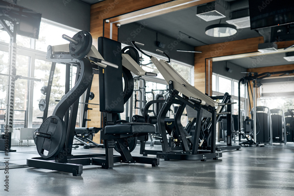 Obraz premium Modern gym interior with weight training machines and no people