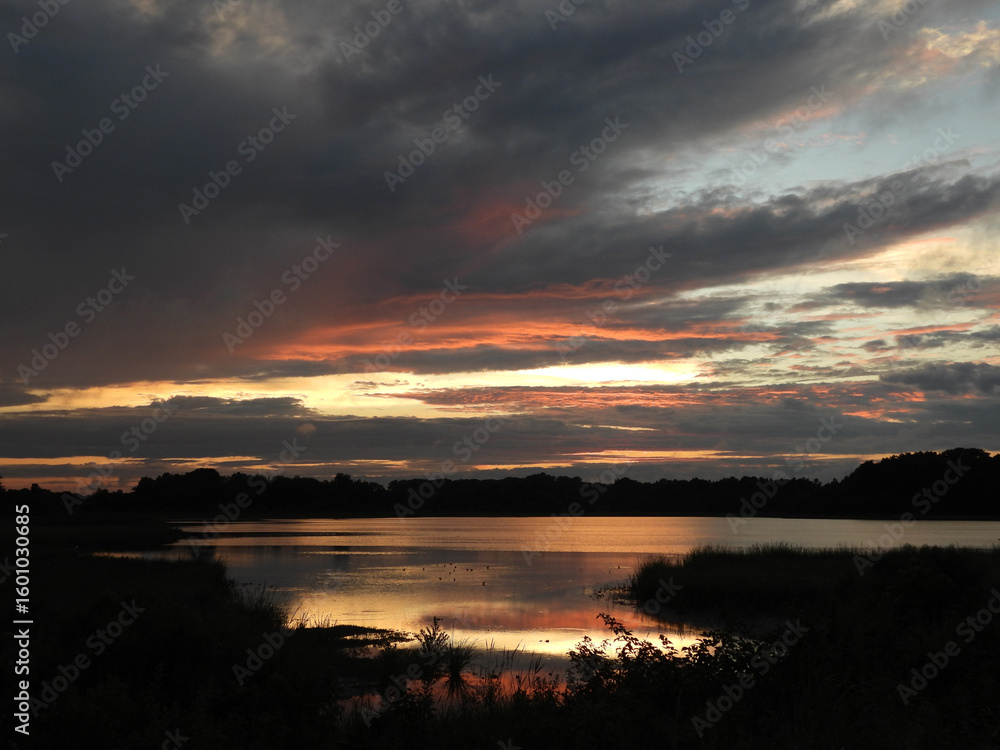 Fototapeta premium The tranquil beauty of the wetlands, as the sun sets. Bombay Hook National Wildlife Refuge, Kent County, Delaware. Remnants of tropical storm Debby.