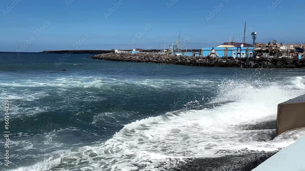 A glimpse of the beach in a village in the south of the island of Tenerife, sunrise on the seafront with sparkling water along the Canarian coast. A glimpse of the beach in a village in the south of the island of Tenerife, sunrise on the seafront with sparkling water along the Canarian coast.