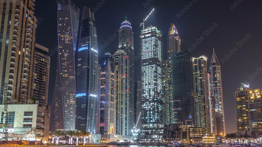 Obraz premium Dubai marina bay with yachts an boats night timelapse