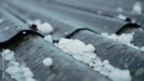 White Hail Pellets Accumulating on a Corrugated Metal Roof During Severe Weather