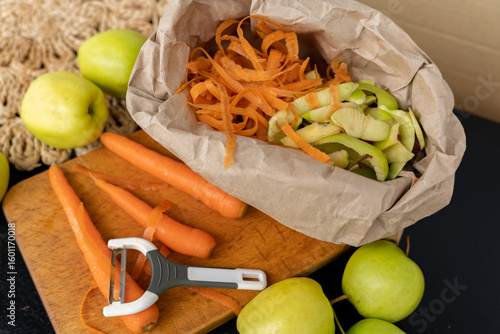 Food organic waste from apple and carrot in a paper bag for organic waste recycling. Organic waste, sorting.