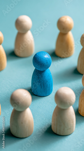 Blue wooden figure stands out among light colored figures wooden figures light wood