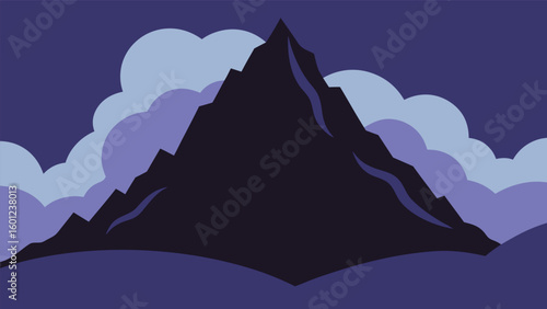 Dark jagged mountain peak emerging from clouds at dusk