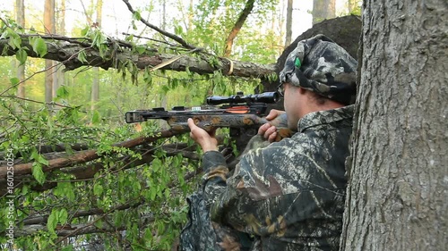 Man hunting with crossbow for Turkey in woods 