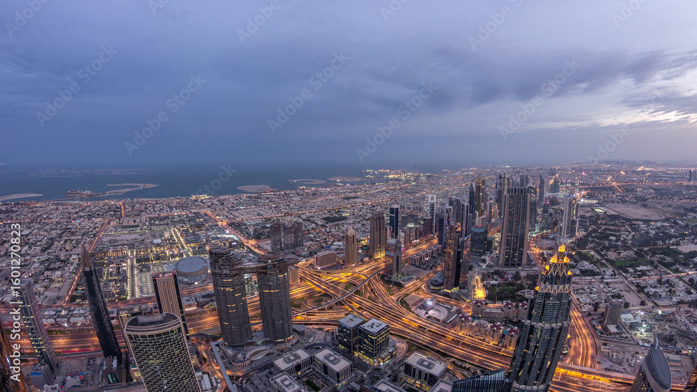 Obraz premium Downtown of Dubai night to day timelapse before sunrise. Aerial view with towers and skyscrapers