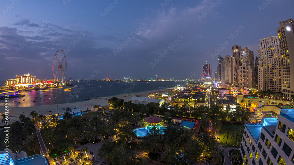 Obraz premium Aerial view of beach and tourists walking in JBR with skyscrapers day to night timelapse in Dubai, UAE