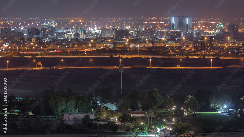 Fototapeta premium Aerial view to villas and houses near Golf course night timelapse