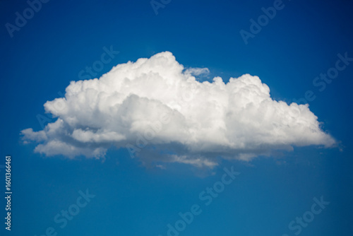 Photos Wide horizontal cumulus cloud stretching across a sunny blue sky