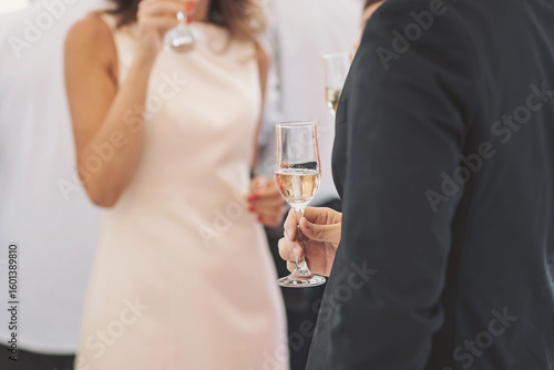 Schilderij op canvas Elegant gathering features guests enjoying sparkling beverages amidst a lively a