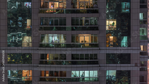 Night view of exterior apartment building timelapse. High rise skyscraper wit...